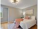 Well-lit bedroom with hardwood floors, modern lighting, and neutral paint at 9493 Timber View Dr, Indianapolis, IN 46250