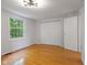 Bedroom featuring hardwood floors, double closet, and natural light from window at 9493 Timber View Dr, Indianapolis, IN 46250