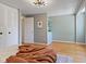 Spacious bedroom featuring wood floors, modern light fixture, closet, and neutral colored walls at 9493 Timber View Dr, Indianapolis, IN 46250