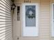 Close up of the home's entrance featuring a white front door with glass and modern exterior lighting at 9493 Timber View Dr, Indianapolis, IN 46250