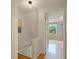 Hallway featuring hardwood floors, white walls, and natural light from window at 9493 Timber View Dr, Indianapolis, IN 46250