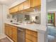 Modern kitchen with stainless steel appliances, light wood cabinets, and a quartz countertop at 9493 Timber View Dr, Indianapolis, IN 46250