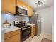 Modern kitchen featuring stainless steel appliances, light wood cabinets and quartz countertops at 9493 Timber View Dr, Indianapolis, IN 46250