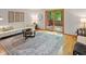 Comfortable living room boasts hardwood floors, neutral decor, and sliding door access to outdoor deck at 9493 Timber View Dr, Indianapolis, IN 46250