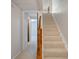 Carpeted staircase with white walls leading to a finished basement at 9493 Timber View Dr, Indianapolis, IN 46250