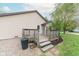 A weathered back deck provides a cozy outdoor space, complementing the home's exterior and green yard at 980 Red Maple Ct, Greenwood, IN 46143