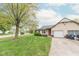 Landscaped front yard of a single-Gathering home with an attached garage and a concrete driveway at 980 Red Maple Ct, Greenwood, IN 46143