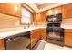 Functional kitchen featuring wood cabinets, black appliances, and tile backsplash, ideal for cooking at 980 Red Maple Ct, Greenwood, IN 46143