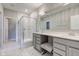 Luxurious bathroom with marble tile, a glass shower, and double vanity sinks at 9823 Pica Dr, Fishers, IN 46040