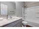 Clean bathroom with a shower-tub, grey vanity, and grey countertop at 9823 Pica Dr, Fishers, IN 46040