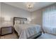 Comfortable bedroom with soft, neutral decor, a large bed, and side tables with lamps at 9823 Pica Dr, Fishers, IN 46040