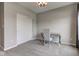 Bright bedroom featuring a desk, chair, and closet, all illuminated by a stylish chandelier at 9823 Pica Dr, Fishers, IN 46040