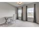 Well-lit bedroom with two large windows, a desk, and an elegant chair at 9823 Pica Dr, Fishers, IN 46040