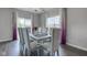 Dining room features large windows, modern chandelier, and seating for eight at 9823 Pica Dr, Fishers, IN 46040
