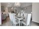 Formal dining room with modern chandelier and seating for eight at 9823 Pica Dr, Fishers, IN 46040