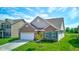 Beautiful home with green lawn, brick facade, green shutters, and a two-car garage at 9823 Pica Dr, Fishers, IN 46040