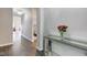Elegant hallway with wood floors, a decorative console table, and a view into other rooms at 9823 Pica Dr, Fishers, IN 46040