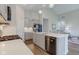 Modern kitchen featuring gray cabinets, stainless steel appliances, quartz countertops, and an open layout at 9823 Pica Dr, Fishers, IN 46040