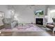 Cozy living room features a fireplace, plush seating, and ample natural light at 9823 Pica Dr, Fishers, IN 46040