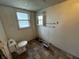 Modest bathroom featuring a standard toilet, small window, and basic fixtures at 9976 W Center St, Anderson, IN 46011