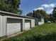 Exterior view of a two-car garage with a house visible in the background and green grass at 9976 W Center St, Anderson, IN 46011