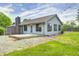Back exterior view of the house with a wooden deck and large backyard at 101 N Westbury Rd, Pendleton, IN 46064