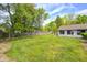Spacious backyard with a well-maintained lawn, a wooden fence, and mature trees offering shade and privacy at 101 N Westbury Rd, Pendleton, IN 46064