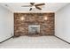 Finished basement featuring a brick fireplace with wood stove insert and ambient lighting at 101 N Westbury Rd, Pendleton, IN 46064