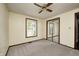 A beige bedroom with light colored carpet, window and closet with mirrored sliding doors at 101 N Westbury Rd, Pendleton, IN 46064