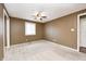 A standard bedroom with beige carpet, a ceiling fan, and a window with blinds at 101 N Westbury Rd, Pendleton, IN 46064