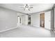This bedroom has carpeted floors, gray walls, a ceiling fan, and an attached bathroom at 101 N Westbury Rd, Pendleton, IN 46064