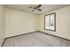 A simple bedroom with carpet, one window, and neutral-toned walls, with ceiling fan at 101 N Westbury Rd, Pendleton, IN 46064