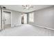 This bedroom has carpeted floors, gray walls, a ceiling fan, and a window with a view of the yard at 101 N Westbury Rd, Pendleton, IN 46064