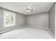 This bedroom has carpeted floors, gray walls, a ceiling fan, and a window with a view of the yard at 101 N Westbury Rd, Pendleton, IN 46064