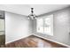 This dining room features wood floors, gray walls and a view out of a window of the front yard at 101 N Westbury Rd, Pendleton, IN 46064