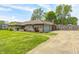 Brick home with attached garage, a long driveway, and a green lawn, creating a welcoming curb appeal at 101 N Westbury Rd, Pendleton, IN 46064