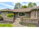Charming brick home featuring a well-manicured front garden, decorative shutters, and a welcoming entryway at 101 N Westbury Rd, Pendleton, IN 46064
