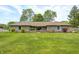 Charming brick home featuring a lush green lawn, mature trees, and lovely landscaping at 101 N Westbury Rd, Pendleton, IN 46064