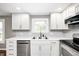 Close-up of a bright kitchen featuring stainless steel appliances and white cabinets and subway tile backsplash at 101 N Westbury Rd, Pendleton, IN 46064