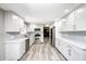 This bright kitchen has recessed lights, stainless steel appliances, gray backsplash, and white cabinets at 101 N Westbury Rd, Pendleton, IN 46064