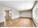 Open floor plan with hardwood floors connecting the living area to the adjacent kitchen at 101 N Westbury Rd, Pendleton, IN 46064