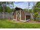 Exterior view of the backyard wooden storage shed with white trim at 101 N Westbury Rd, Pendleton, IN 46064