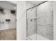 Bathroom showing the walk-in glass shower with marble tile, and a peak into the walk-in closet at 1067 Marston Ln, Avon, IN 46123