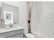 Bright bathroom featuring a light gray vanity with white countertop and a shower/tub combo at 1067 Marston Ln, Avon, IN 46123