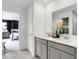 Bright bathroom features a double vanity, quartz countertop and a view into the primary bedroom at 1067 Marston Ln, Avon, IN 46123