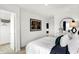 Bright bedroom showcasing a decorative wall mirror, soft textures, and convenient closet access at 1067 Marston Ln, Avon, IN 46123