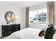 Comfortable bedroom featuring a large window with neighborhood view, and a black dresser at 1067 Marston Ln, Avon, IN 46123