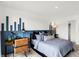 Stylish bedroom with blue accent wall, modern furnishings, and comfortable bed at 1067 Marston Ln, Avon, IN 46123