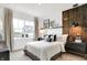 Beautiful bedroom with a decorative wood accent wall, and a large window showcasing the neighborhood at 1067 Marston Ln, Avon, IN 46123
