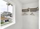 Bright closet features wire shelving, two storage baskets and a street view through a window at 1067 Marston Ln, Avon, IN 46123